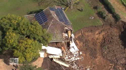 A farm north of Sydney that was underwater just days ago is now crumbling into an enormous sinkhole.