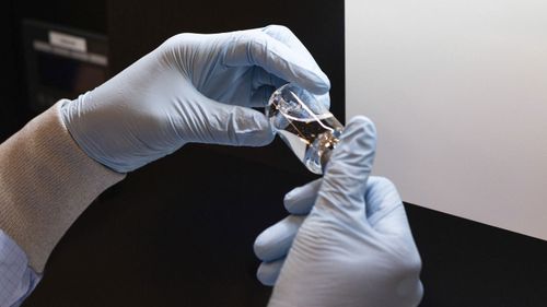 A vial of the investigational drug remdesivir is visually inspected at a Gilead manufacturing site in the United States.