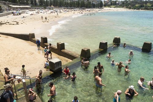 People enjoy the summer weather at Coogee beach.