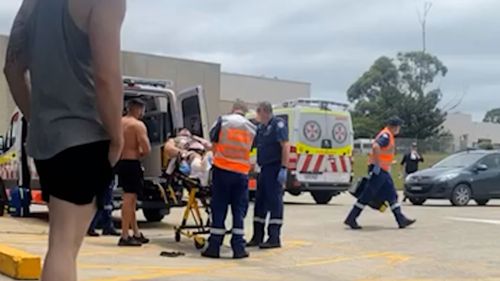 Paramedics load the injured man into the back of an ambulance, after the shooting in Prospect, in Sydney's west.