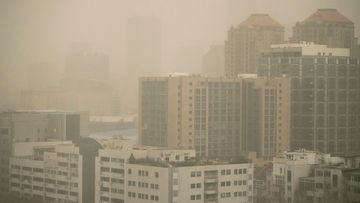 Haze and dust envelops buildings in Beijing, Friday, March 10, 2023. 