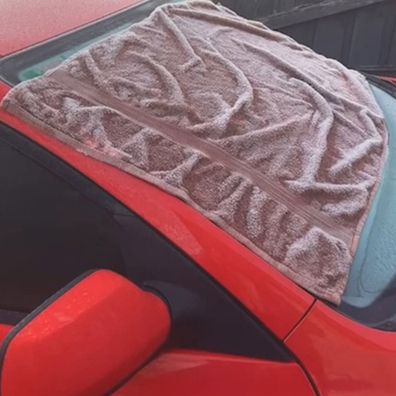 Towel hack stops car windscreen getting icy overnight
