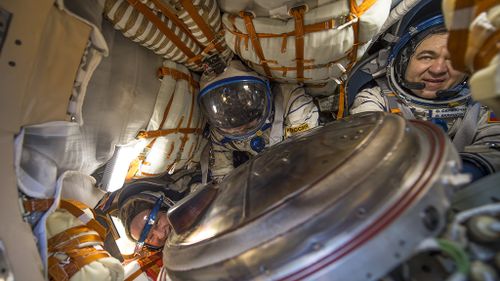 Astronauts Williams, left, and Russian cosmonauts Alexey Ovchinin, center, and Oleg Skripochka, of Roscosmos, inside the Soyuz TMA-20M after landing on Earth. (AAP)