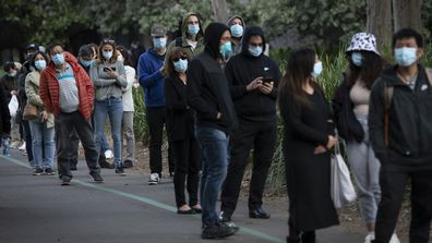 People wait in line at the mass vaccination centre at Sydney Olympic Park.