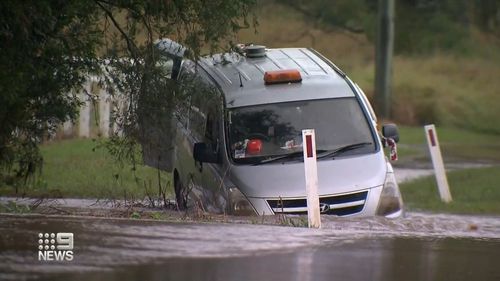 The car with the two men and two dogs inside was swept off a bridge by a torrent of water in the rapidly rising floods in Morwincha, in the Scenic Rim region of Queensland. 