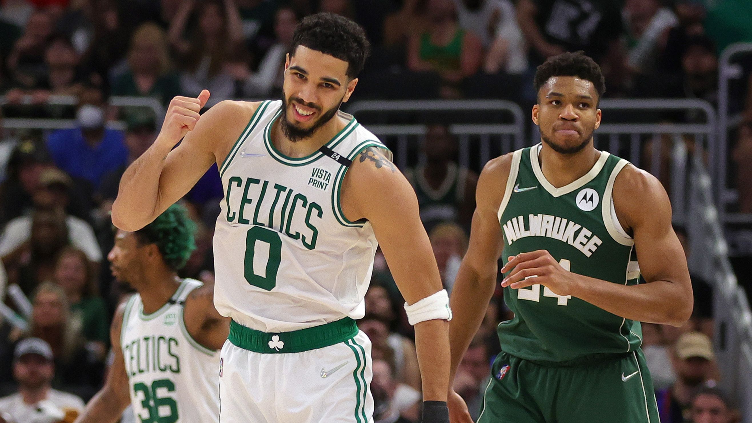 Jayson Tatum celebrates a basket against Giannis Antetokounmpo during game six of the 2022 NBA playoffs Eastern Conference semifinals.