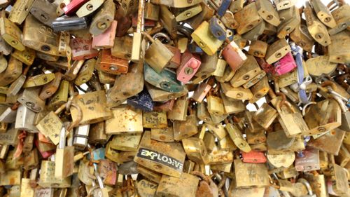 Padlocks locked and left as a symbol of love on Parisian bridges, displayed during an auction organised by the Ville de Paris. (AFP)