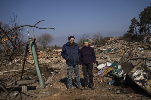 Farmer Valerie Puzakovi, 56, left, poses for the picture with his wife Svitalna,  a few block from their home in Yasnogorodk, a rural town where the Ukrainian army stopped the advance of the Russian army, outskirts of Kyiv, Ukraine, Friday, March 25, 2022. 