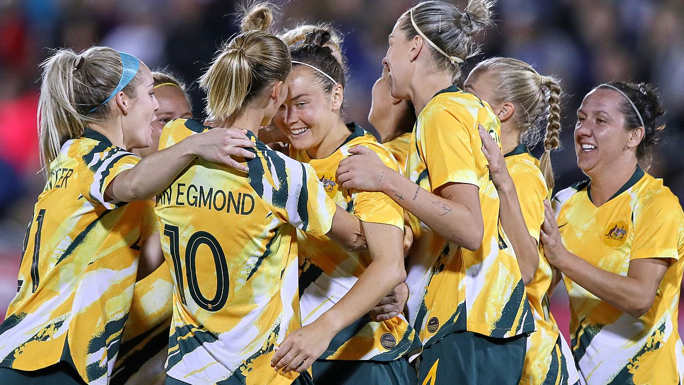 Australia forward Caitlin Foord (9) celebrates with Australia midfielder Emily Van Egmond (10) and teammates after scoring a goal