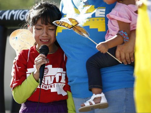 Akemi Vargas, 8, cries as she talks about being separated from her father during an immigration family separation protest in front of the Sandra Day O'Connor U.S. District Court building. (AAP)