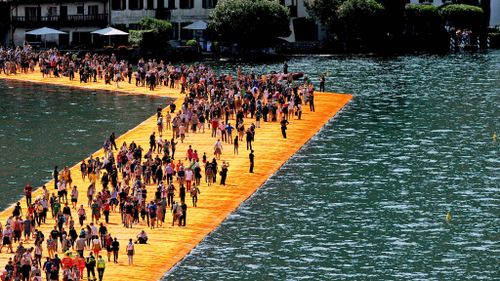 Thousands flock to ‘walk on water’ after artist's lake walkways open in northern Italy
