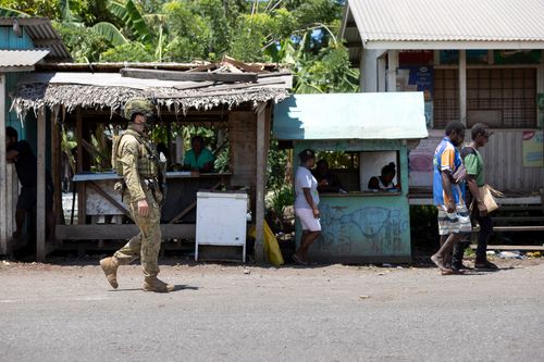 An Australian Army Corporal on patrol though Honiara, Solomon Islands