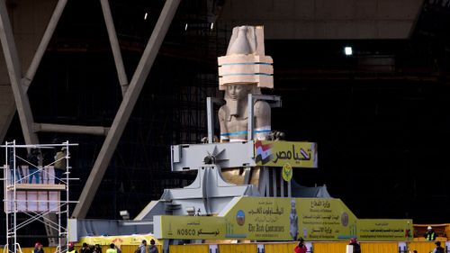 A giant statue of pharaoh Ramses II arrives at the atrium of the Grand Egyptian Museum in Cairo, Egypt. (AAP)