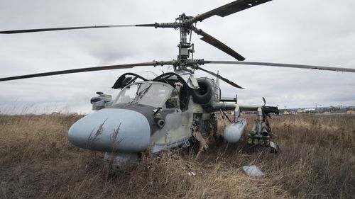 A Russian Ka-52 helicopter gunship is seen in the field after a forced landing outside Kyiv, Ukraine.