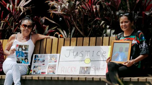 Beryl Dixon and Tiara Kelly, mother and sister of victim Ricky Slater, pose with a tribute to Ricky, outside Newcastle Court.