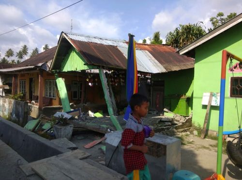 A powerful earthquake has rocked the Indonesian island of Sulawesi, triggering a three-metre-tall tsunami that an official said swept away houses in at least two cities.