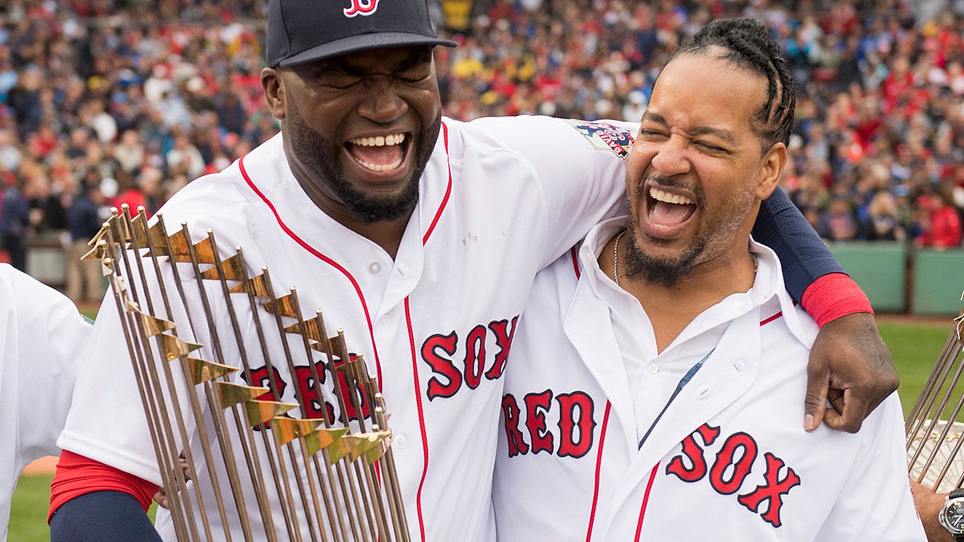 David Oritz #34 of the Boston Red Sox laughs with former teammate Manny Ramirez