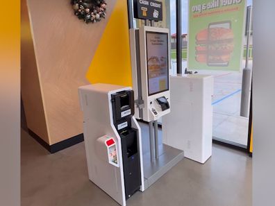 A digital kiosk that people use to order at McDonald's.