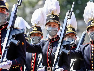 Belgium's Crown Princess Elisabeth, center, marches past the Royal tribune with cadets of the military school during the National Day parade in Brussels, Wednesday, July 21, 2021. Belgium celebrates its National Day on Wednesday in a scaled down version due to coronavirus, COVID-19 measures. (Laurie Dieffembacq, Pool Photo via AP)