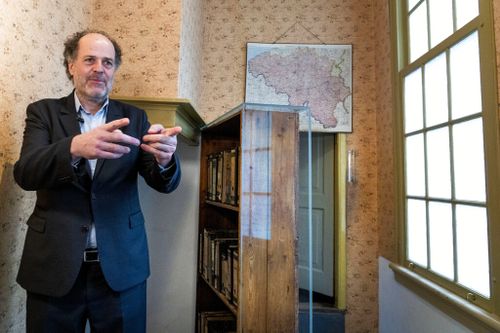 Ronald Leopold, executive director of Anne Frank House, gestures as he talks next to the passage to the secret annex during an interview in Amsterdam.