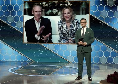 NEW YORK, NEW YORK: 78th Annual GOLDEN GLOBE AWARDS -- Pictured: Catherine O'Hara (c) accepts the Best Television Actress  Musical/Comedy Series award for Schitt's Creek via video (with Bo Welch, l) from Christian Slater onstage at the 78th Annual Golden Globe Awards held at The Rainbow Room and broadcast on February 28, 2021 in New York, New York. -- (Photo by Peter Kramer/NBC/NBCU Photo Bank via Getty Images)