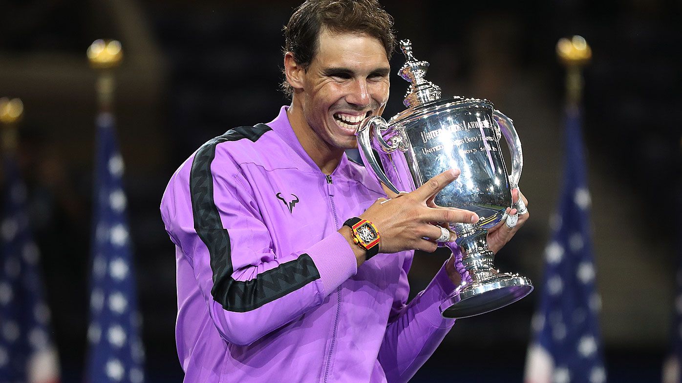 Rafael Nadal of Spain celebrates with the championship trophy during the trophy presentation ceremony