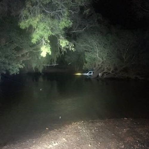 Two motorists have been forced to spend nine hours trapped in croc infested waters over the Easter Weekend, following a trip into flood waters in the Northern Territory. 