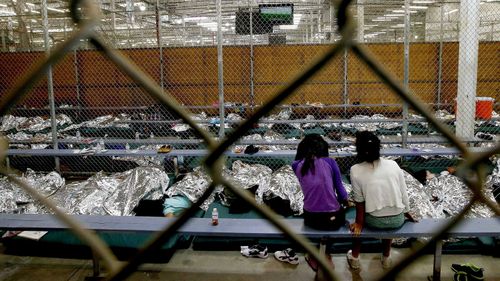 Photos show young children sprawled on mattresses on cold floors, with only silver space blankets for protection and comfort. (AP)