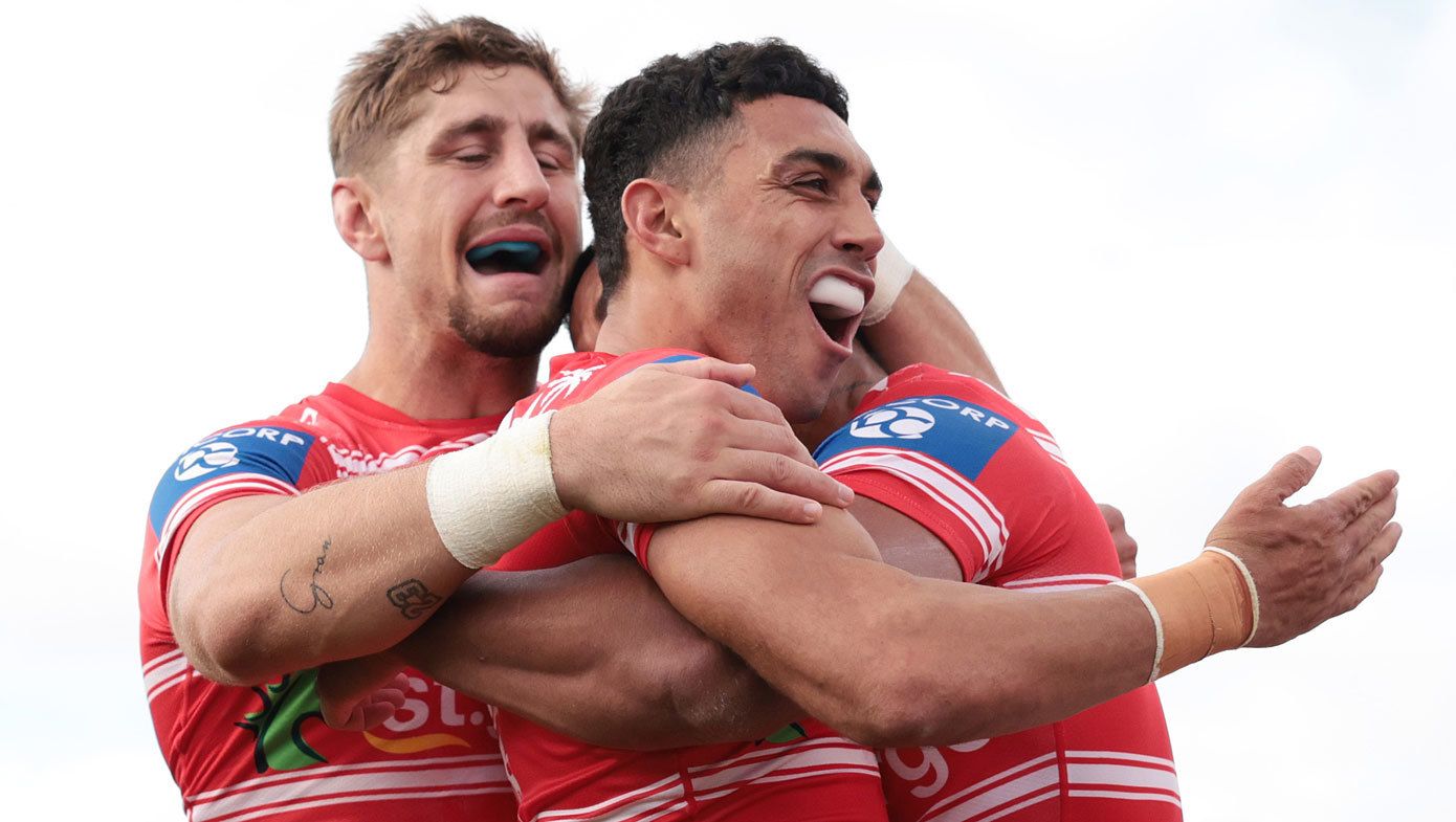 Zac Lomax and Tyrell Sloan celebrate a try with Dragons teammate Mat Feagai against the Raiders in 2023.