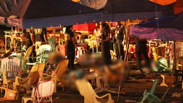 Police investigators collect evidence at the site of an explosion at a night market in Davao City. (AFP)