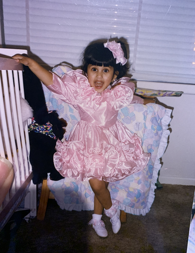 Model and advocate Maria Thattil pictured as a little girl, wearing a pink dress
