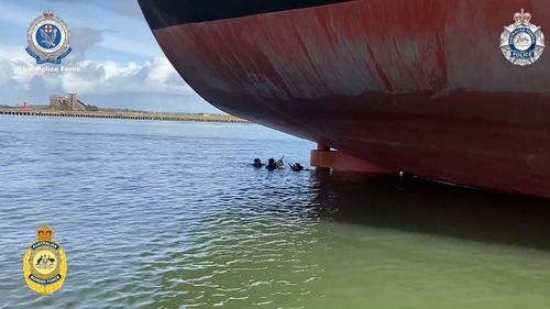 A dead scuba diver found near more than 50kg of cocaine at a Newcastle shipping port has been identified as a foreign national.