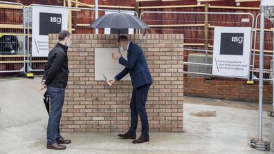 Prince William, Duke of Cambridge looks at a plaque to mark the construction of the groundbreaking Oak cancer centre at Royal Marsden Hospital on October 21, 2020 in Sutton, Greater London.