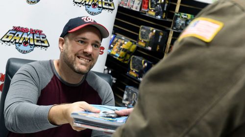 Batman comic author Tom King hands out free comics to US government workers affected by the shutdown in a special signing event in Baltimore.