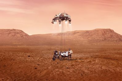 This illustration provided by NASA shows the Perseverance rover, bottom, landing on Mars. Entry, Descent, and Landing, or "EDL," begins when the spacecraft reaches the top of the Martian atmosphere. (NASA/JPL-Caltech via AP)