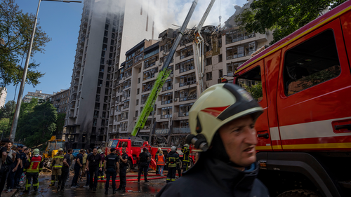 Firefighters work at the scene of a residential building following explosions, in Kyiv, Ukraine, Sunday, June 26, 2022. 