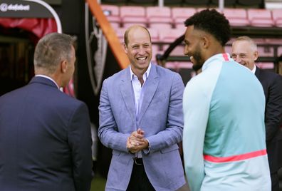 Prince William, Prince of Wales (centre) during a visit to Bournemouth AFC's Vitality Stadium in Dorset 