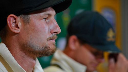 A grim-faced Cameron Bancroft speaks to the media with his sullen captain alongside. Picture: AAP