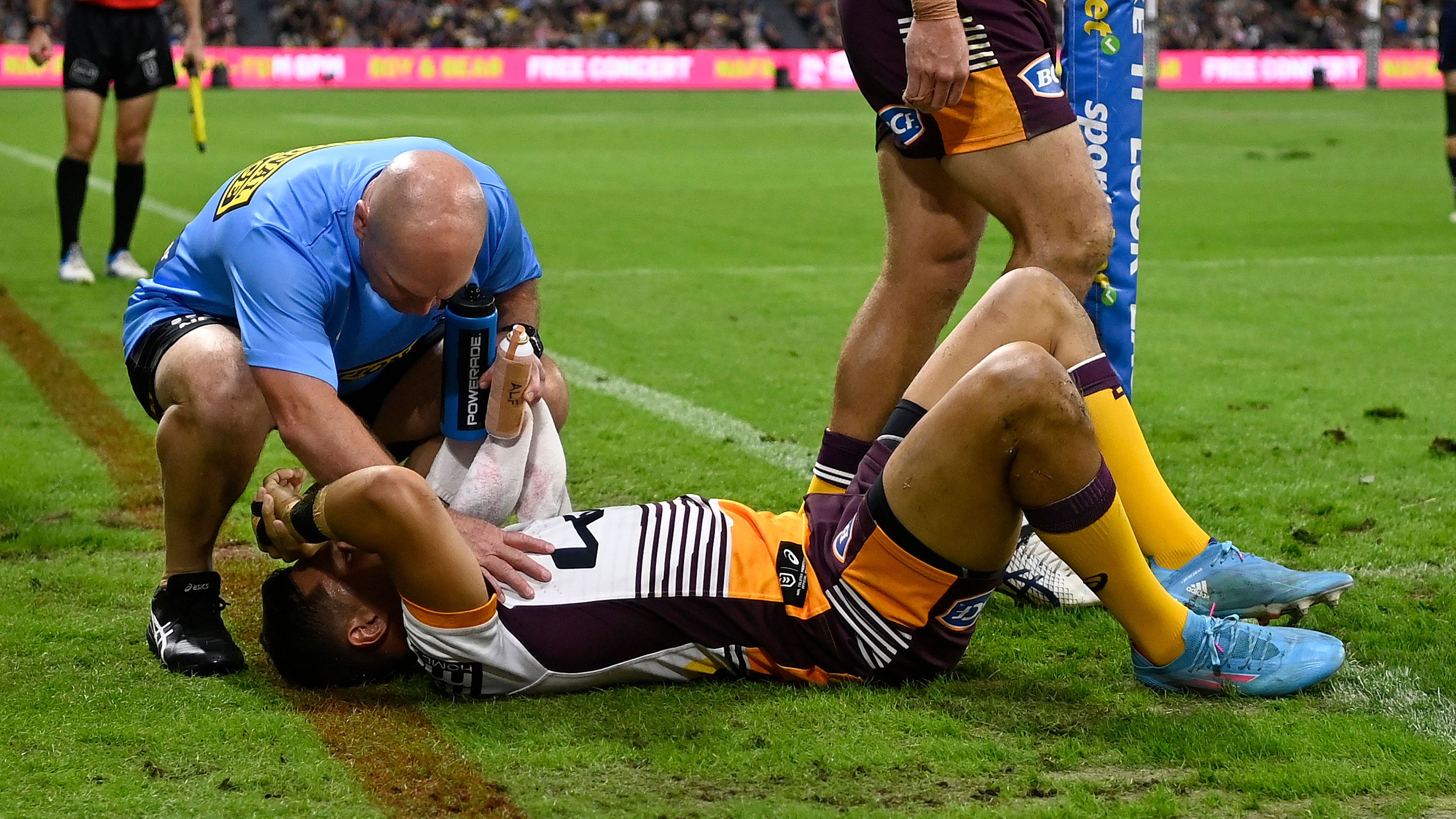 Te Maire Martin of the Broncos receives treatment after being injured during the round 16 match against the Cowboys.