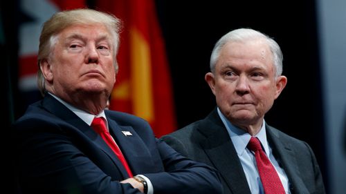 President Donald Trump sits with Attorney General Jeff Sessions during the FBI National Academy graduation ceremony in Quantico, Virginia in December 2017. (AAP)