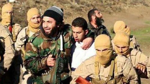 The man purported to be a Jordanian pilot (in white) with ISIL fighters. (AAP)