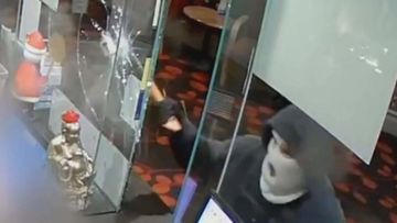 A hooded bandit armed with an axe has been captured on CCTV unleashing against innocent workers at an Adelaide hotel.