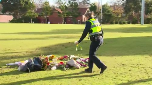 A police officer was seen laying a rose for Ms Dixon. (9NEWS)