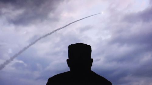 Kim Jong-un watches a missile being launched.