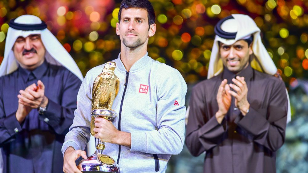 Novak Djokovic enjoys the spoils of victory in Qatar. (AAP)