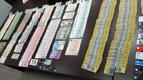 The men were arrested with a large amounts of various currencies. (Serbian Interior Ministry)