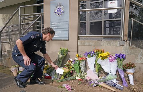 Victoria Police Deputy Commissioner Shane Patton lays a tribute at Boroondara Police near the Chandler Highway in the suburb of Kew in Melbourne, Thursday, April 23, 2020. Four police officers have died in a horror crash involving a truck on Melbourne's Eastern Freeway. (AAP Image/Scott Barbour) NO ARCHIVING