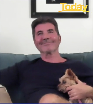 The dog barked during the interview so Cowell picked her up.