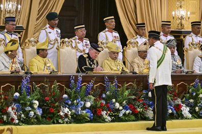 Sultan Ibrahim Sultan Iskandar, center left in front, signs documents during the oath taking ceremony as the Malaysias 17th king at the National Palace in Kuala Lumpur in Kuala Lumpur, Malaysia Wednesday, Jan. 31, 2024.  