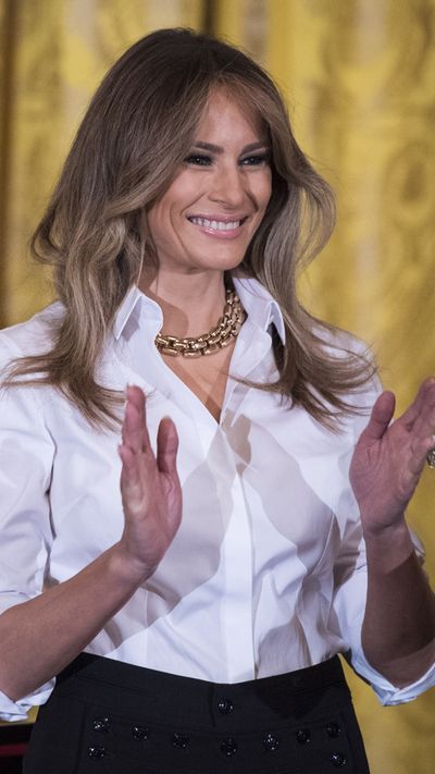 Melania Trump in a white shirt and black Ralph Lauren collection skirt.